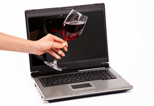 laptop and glass of red wine